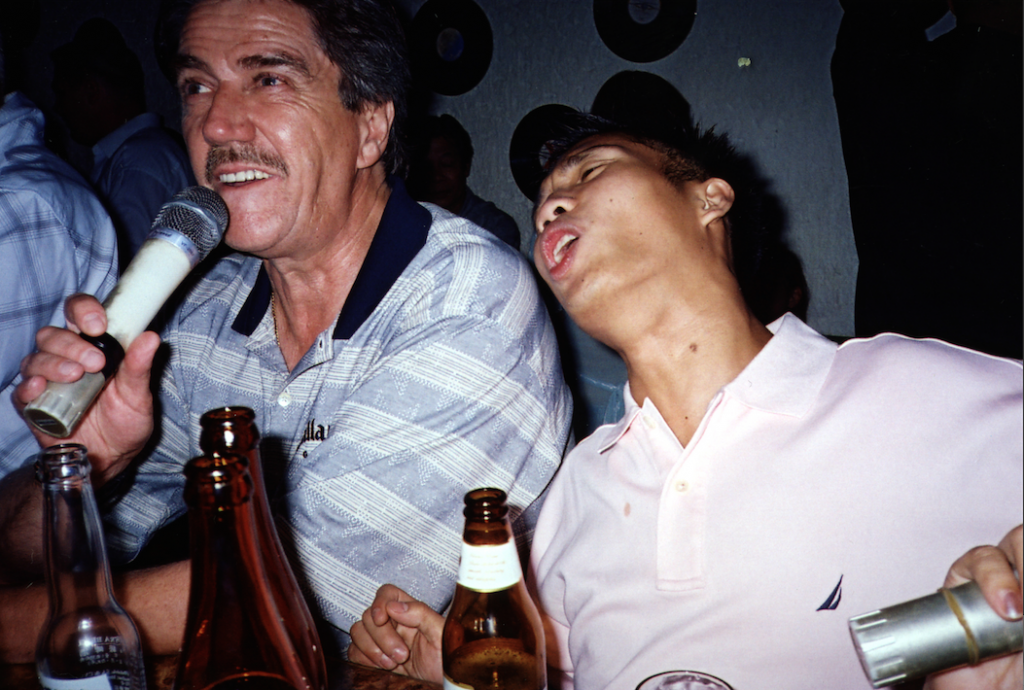 Alex Pagulayan and Cliff Thorburn sing in a local bar after Alex's 2004 World Pool Championship win in Taipei, Taiwan...